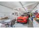 Garage with a red Ford Mustang and additional workspace at 37652 New Horizons Blvd, Zephyrhills, FL 33541