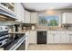 Kitchen features white cabinets, granite countertops, and stainless steel appliances at 37652 New Horizons Blvd, Zephyrhills, FL 33541