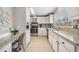 View of a galley style kitchen with white cabinets and granite countertops at 37652 New Horizons Blvd, Zephyrhills, FL 33541