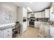 Kitchen with white cabinets, granite countertops, and stainless steel appliances at 37652 New Horizons Blvd, Zephyrhills, FL 33541