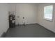 Laundry room with gray floor, water heater, and window at 4201 Dr Martin Luther King Jr N St, St Petersburg, FL 33703