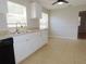 White kitchen cabinets, granite countertops, and black appliances at 4201 Dr Martin Luther King Jr N St, St Petersburg, FL 33703