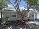 House exterior, gray siding, landscaping, and tree in front at 4201 Dr Martin Luther King Jr N St, St Petersburg, FL 33703