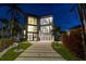 Contemporary home with sleek design and paved driveway at 448 22Nd St, Belleair Beach, FL 33786