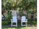 Small patio with white chairs and tropical plants at 4632 Red Maple Rd # 1204, Bradenton, FL 34210