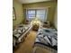 Guest bedroom with two twin-size beds and decorative bedding at 4632 Red Maple Rd # 1204, Bradenton, FL 34210
