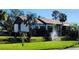 Exterior view of a condo building with lush landscaping and a water feature at 4632 Red Maple Rd # 1204, Bradenton, FL 34210