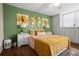 Bedroom with green walls and mustard yellow bedding at 4715 Bay Ne St # 223, St Petersburg, FL 33703