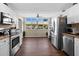 Modern kitchen with white cabinets, granite countertops, and stainless steel appliances at 4715 Bay Ne St # 223, St Petersburg, FL 33703