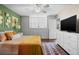 Spacious bedroom with wood floors and a large TV at 4715 Bay Ne St # 223, St Petersburg, FL 33703