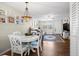 Charming dining area with white table and chairs, near living room at 4715 Bay Ne St # 223, St Petersburg, FL 33703