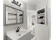 Bright bathroom with white vanity, updated fixtures, and built-in shelving at 4801 Dartmouth N Ave, St Petersburg, FL 33713