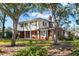 Two-story home showcasing a brick and shingle exterior with large trees at 4801 Dartmouth N Ave, St Petersburg, FL 33713