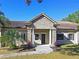 House entrance with stone columns and a tile roof at 5403 Golddust Rd, Spring Hill, FL 34609