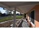 Charming front porch with white columns, decorative items, and a view of the surrounding neighborhood at 552 Trade Winds Dr, Dunedin, FL 34698