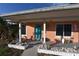 Charming front porch adorned with plants, decorative items, a vibrant front door, and colorful accents at 552 Trade Winds Dr, Dunedin, FL 34698