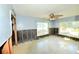 A partially renovated living room featuring two large windows and an eye-catching terrazzo floor at 552 Trade Winds Dr, Dunedin, FL 34698