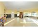 A living room with outdated flooring shows damage to the drywall at 552 Trade Winds Dr, Dunedin, FL 34698