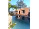 Outdoor pool in the back yard with patio and palm trees at 552 Trade Winds Dr, Dunedin, FL 34698