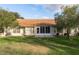 Backyard view of home with screened patio at 5935 Precious View Ct, New Port Richey, FL 34655