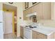 Well-lit kitchen featuring a white oven, light-colored cabinets and neutral countertops at 5935 Precious View Ct, New Port Richey, FL 34655