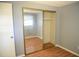 Bedroom with mirrored closet doors and light wood laminate flooring at 603 Highview S Cir, Brandon, FL 33510