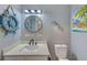 Small bathroom with nautical decor and white vanity at 8467 Austin N # 8467, Pinellas Park, FL 33781