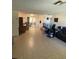 Spacious living room with tiled floors and ample natural light at 8906 Windsong Ln, Port Richey, FL 34668