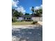 Charming ranch-style home featuring a well-maintained front yard and solar panels at 8906 Windsong Ln, Port Richey, FL 34668