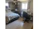 Bright bedroom featuring a queen-size bed and built-in shelving at 8906 Windsong Ln, Port Richey, FL 34668