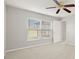 Spacious bedroom featuring a large window and ceiling fan at 10306 Chatuge Dr, San Antonio, FL 33576