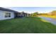 Backyard showcasing home's exterior and pond view at 10306 Chatuge Dr, San Antonio, FL 33576