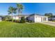 House front with palm trees and a two-car garage at 10306 Chatuge Dr, San Antonio, FL 33576