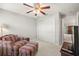 Bedroom with armchair, ottoman, and double doors to a sitting area at 10306 Chatuge Dr, San Antonio, FL 33576