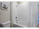 Full bathroom with tub shower combo and white tile at 10551 Tranquil Meadow Loop, Riverview, FL 33569