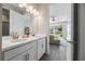 Modern bathroom with double vanity and view of the backyard at 10551 Tranquil Meadow Loop, Riverview, FL 33569