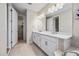 Double vanity bathroom with access to a walk-in closet at 10551 Tranquil Meadow Loop, Riverview, FL 33569