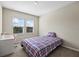 Bedroom with plaid bedding, desk, and two windows at 10551 Tranquil Meadow Loop, Riverview, FL 33569