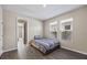 Cozy bedroom with striped bedding and access to another room at 10551 Tranquil Meadow Loop, Riverview, FL 33569