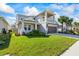 Two-story house with gray siding, landscaping and driveway at 10551 Tranquil Meadow Loop, Riverview, FL 33569