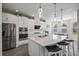 Modern kitchen with white cabinets, stainless steel appliances, and a large island at 10551 Tranquil Meadow Loop, Riverview, FL 33569