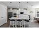 Modern kitchen with white cabinets, stainless steel appliances, and a large island at 10551 Tranquil Meadow Loop, Riverview, FL 33569