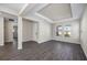 Open living area with wood-look tile flooring and neutral walls at 10551 Tranquil Meadow Loop, Riverview, FL 33569