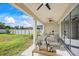 Relaxing patio furniture on covered patio with ceiling fan at 10551 Tranquil Meadow Loop, Riverview, FL 33569
