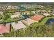 Aerial view of neighborhood, showing homes and green spaces at 15613 Aurora Lake Cir, Wimauma, FL 33598