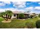 Landscaped backyard with a screened enclosure at 1623 Faxton Dr, Sun City Center, FL 33573