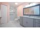 Updated bathroom with a walk-in shower, granite vanity, and tiled floors at 1623 Faxton Dr, Sun City Center, FL 33573