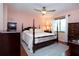 Main bedroom with a king-size bed and wood dresser at 1623 Faxton Dr, Sun City Center, FL 33573