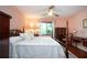Spacious bedroom with a king-size bed, dresser, and hardwood floors at 1623 Faxton Dr, Sun City Center, FL 33573