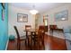 Charming dining room with a round table and four chairs, hardwood floors at 1623 Faxton Dr, Sun City Center, FL 33573